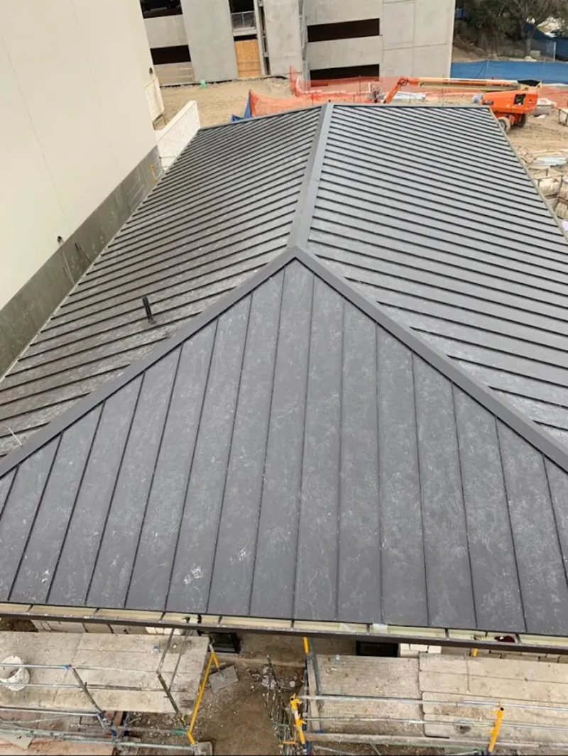 Commercial metal roof construction with crane equipment in Palm City