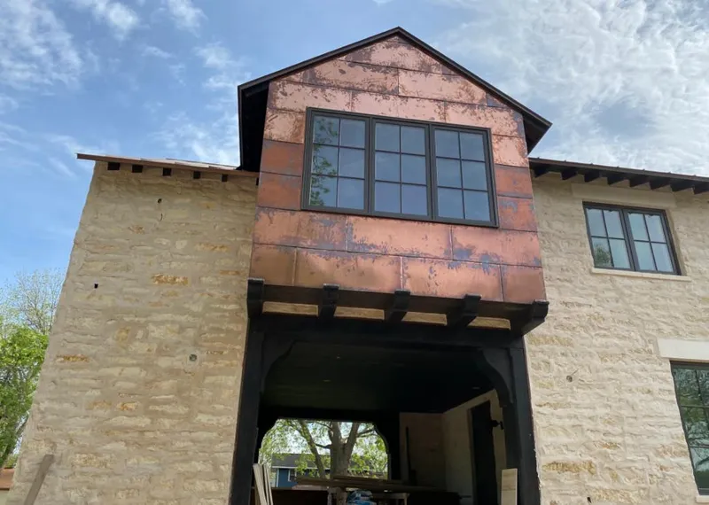 Copper metal panel facade on a stone building for Skylight Installation in Palm City