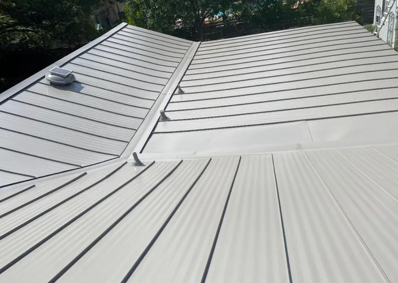 Solar attic fan installed on a metal roof for Roof Ventilation in Palm City